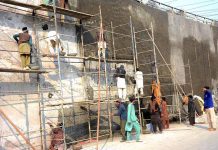Masons are plastering on the wall of Kalma Chowk underpass