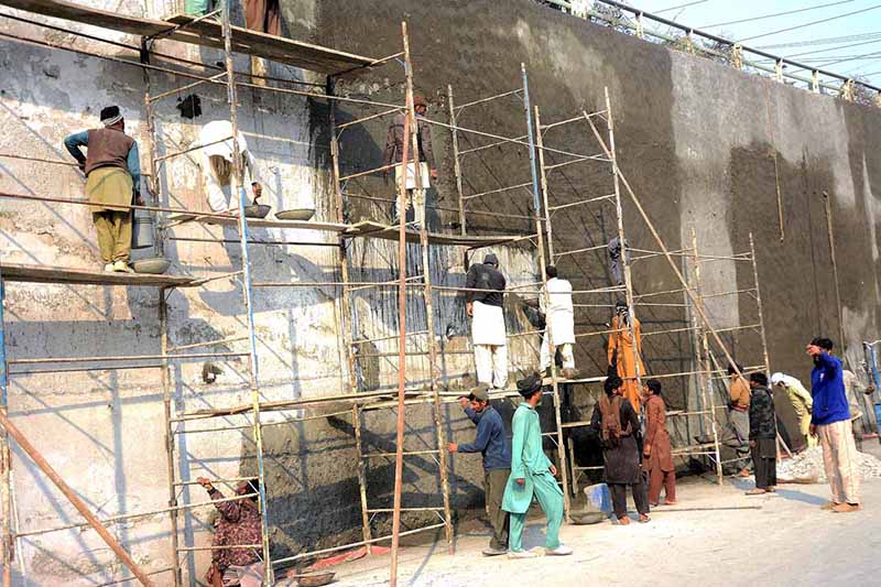 Masons are plastering on the wall of Kalma Chowk underpass