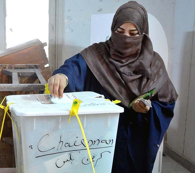 A woman voter casting her vote in a polling station in the second phase of the local government elections