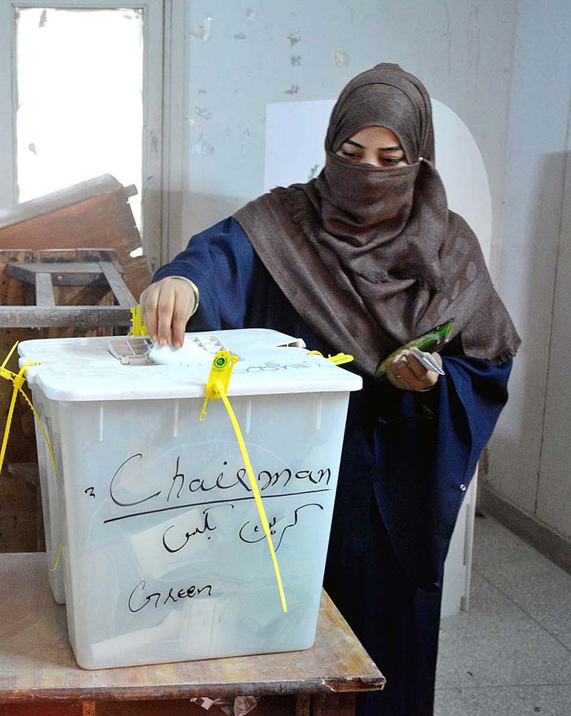 A woman voter casting her vote in a polling station in the second phase of the local government elections