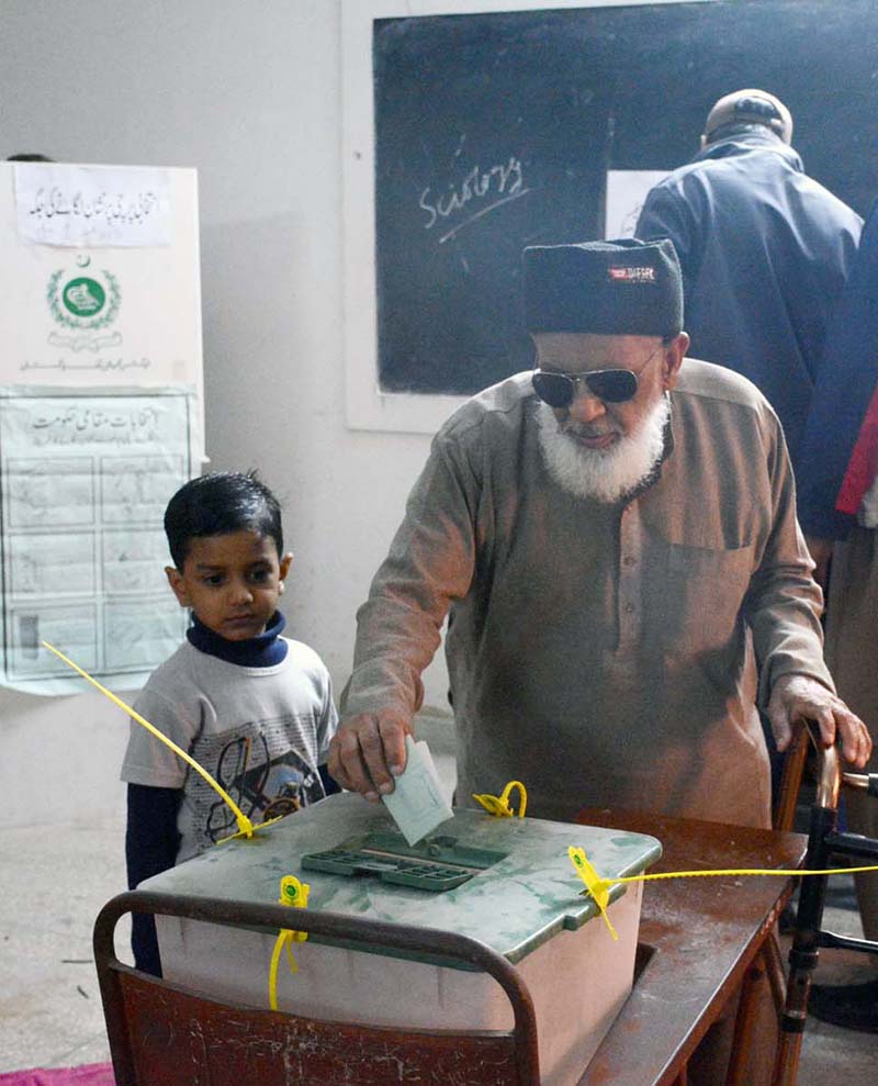 A woman voter casting her vote in a polling station in the second phase of the local government elections
