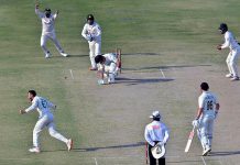 Pakistan's bowler Agha Salman celebrates after the dismissal of New Zealand's Daryl Mitchell (R) during the first day of the second cricket Test match between Pakistan and New Zealand at the National Stadium