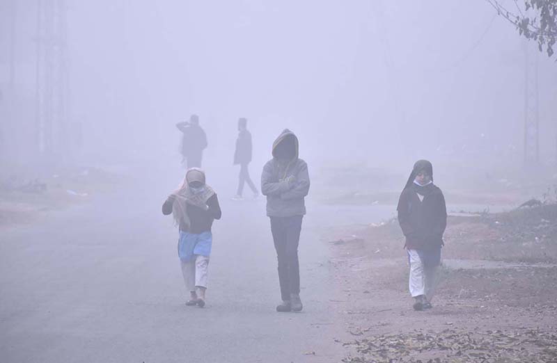 Students are going to their school during dense fog during extreme cold weather in the Provicnial capital city