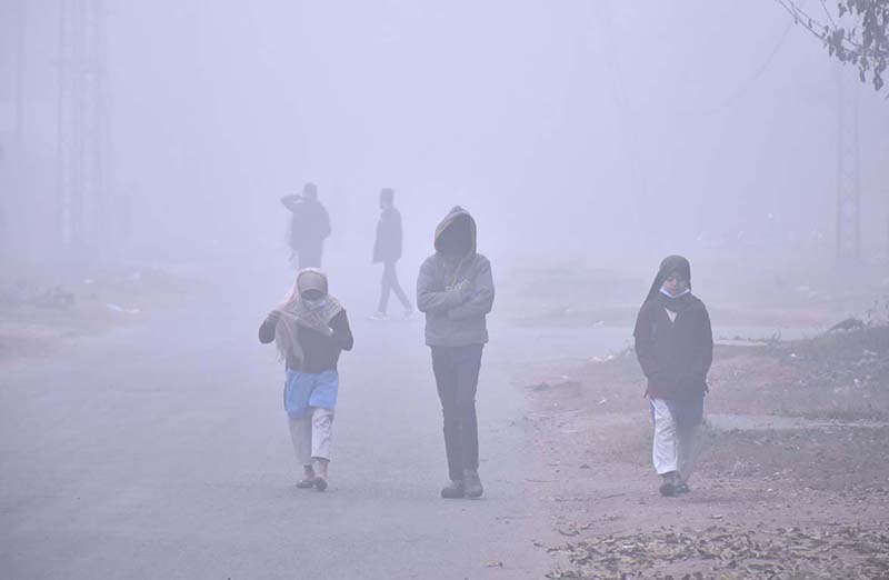 Students are going to their school during dense fog during extreme cold  weather in the Provicnial capital city