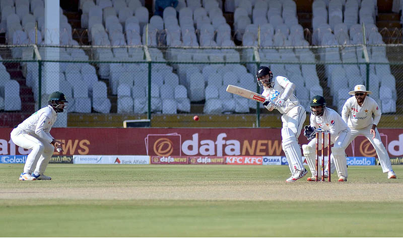 Pakistan's bowler Agha Salman celebrates after the dismissal of New Zealand's Daryl Mitchell (R) during the first day of the second cricket Test match between Pakistan and New Zealand at the National Stadium