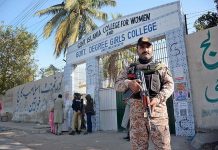 A Rangers cop standing alert position outside a polling station in the second phase of the local government elections