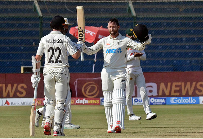 Pakistan's bowler Agha Salman celebrates after the dismissal of New Zealand's Daryl Mitchell (R) during the first day of the second cricket Test match between Pakistan and New Zealand at the National Stadium