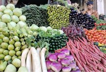 A vendor displaying fresh vegetables to attract the customers at his shop