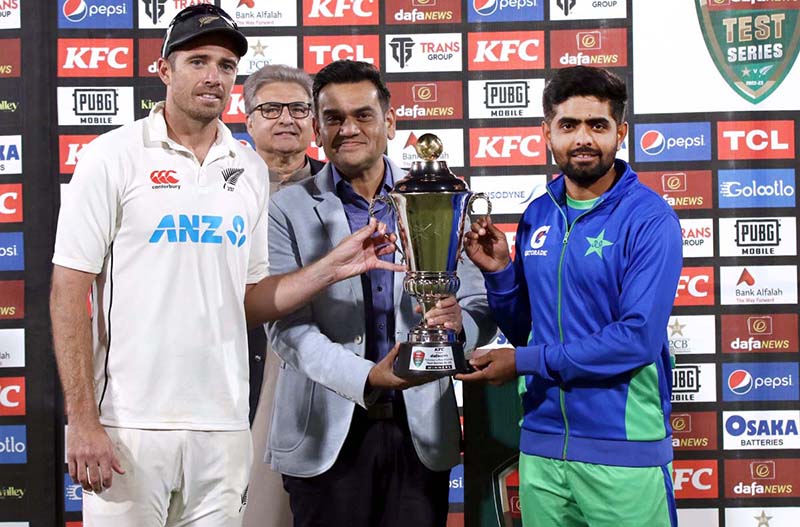 Pakistan Cricket Team captain Babar Azam and New Zealand's captain Tim Southee pose with the trophy after Draw Test Series during the fifth and final day of the Second Cricket Test Match between Pakistan and New Zealand at the National Stadium