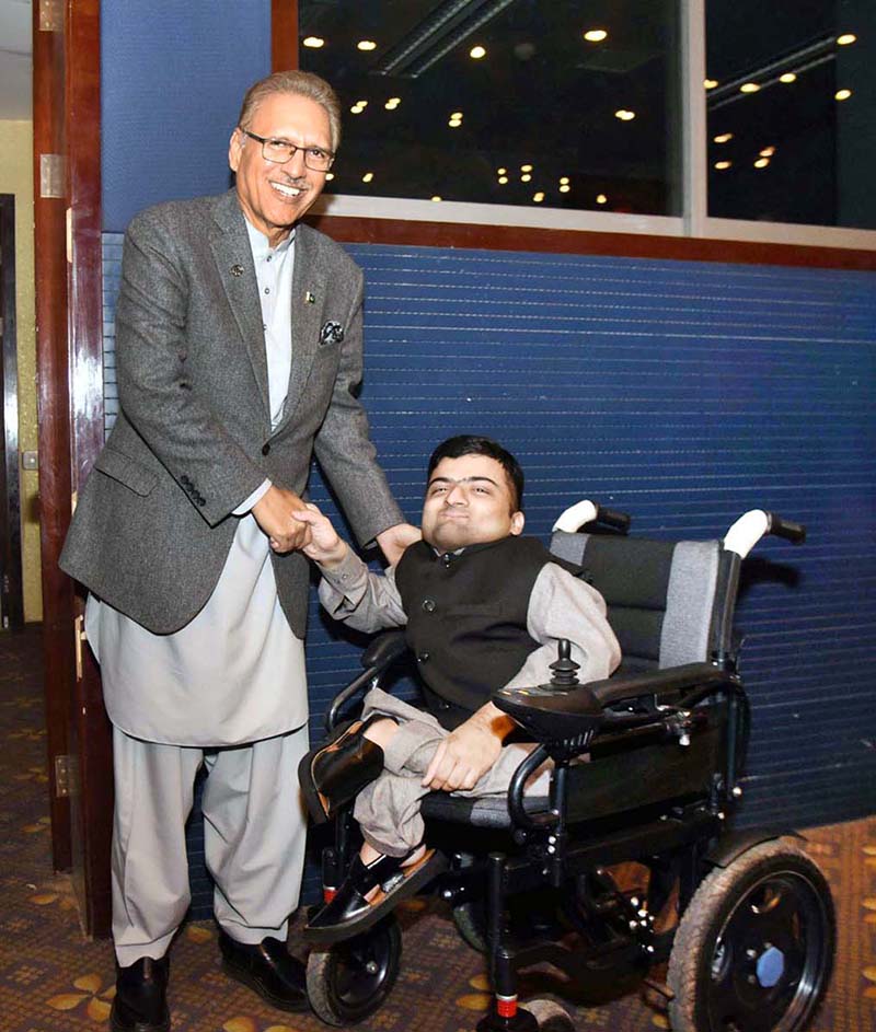 President Dr. Arif Alvi meeting with a differently-abled person, who was attending the Global Digital Summit