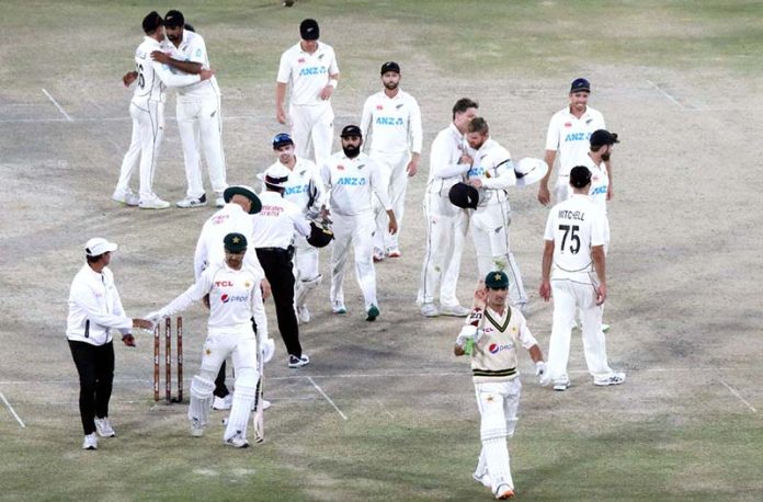 Pakistan players Naseem Shah and Abrar Ahmed along with New Zealand team back after Drawn Match and Test Series during the fifth and final day of the second cricket Test match between Pakistan and New Zealand at the National Stadium