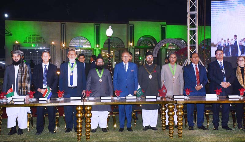 President Dr Arif Alvi and others stand as national anthem of Pakistan plays in a gala dinner hosted to honor foreign and national delegates of International Medical Education Conference at College Of Physician And Surgeon