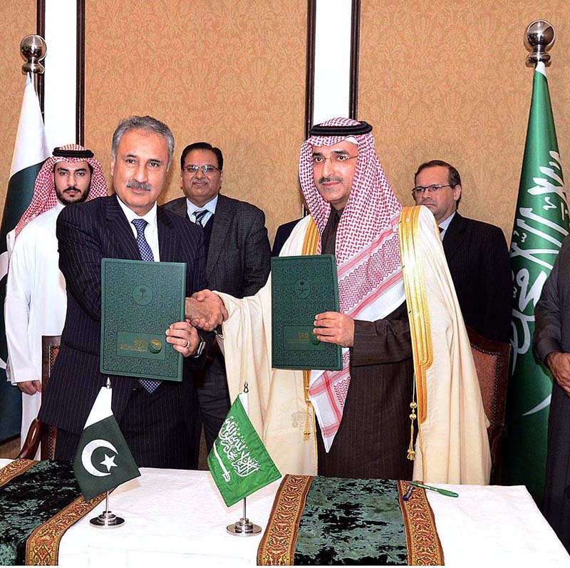 Secretary Ministry of Economic Affairs Dr. Kazim Niaz and CEO of the Saudi Fund for Development (SFD) Sultan Abdulrahman Al-Marshad exchange documents after signed an agreement to finance oil derivatives worth USD 1 billion to Pakistan