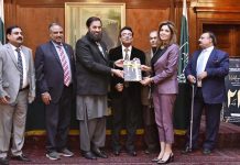 Punjab Governor Balighur Rehman presenting the book to author and human rights activist Farzana Aqib during the book launch ceremony of Sajjad Parvez