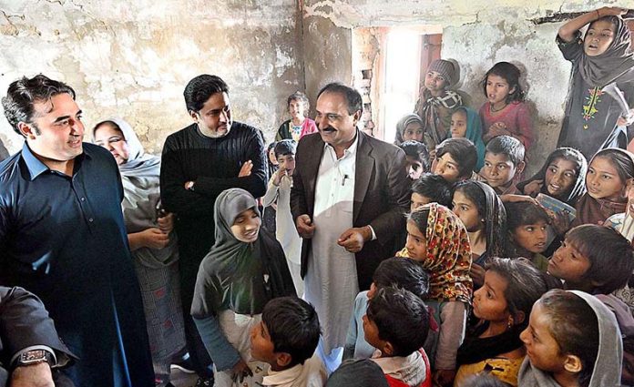 Chairman Pakistan People's Party and Foreign Minister Bilawal Bhutto Zardari talking with students of flood damaged school during his visit to the flood affected area of Sita Village near Dadu