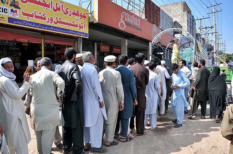 A large number of people standing in a queue to purchase flour bags on subsidized rate at Lehtrar Road