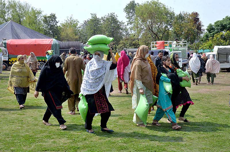 Women on the way after getting free flour bags under Ramadan package at Liaqat Bagh.