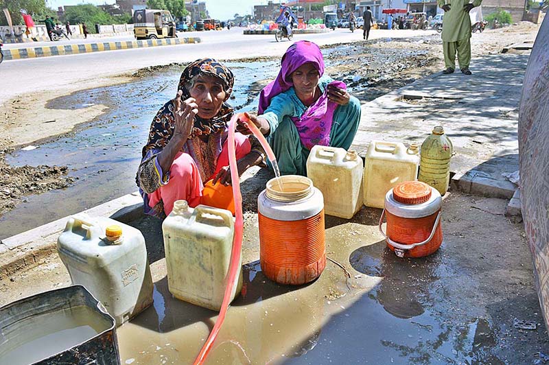 Gypsy women busy in filling their pots with clean water at Husseinabad