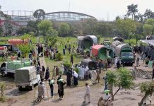 People getting free flour bags under Ramadan package at Liaqat Bagh.