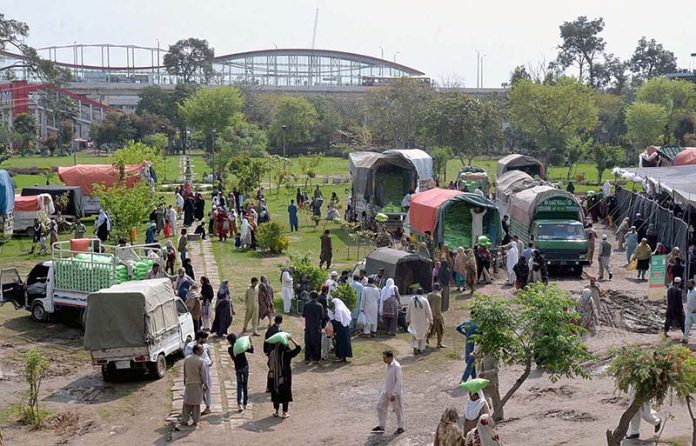 People getting free flour bags under Ramadan package at Liaqat Bagh.