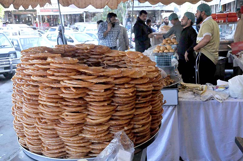 Vendors displaying traditional sweet item (Jalebi) for iftar at Karachi Company during Holy month of Ramzan in Federal Capital.