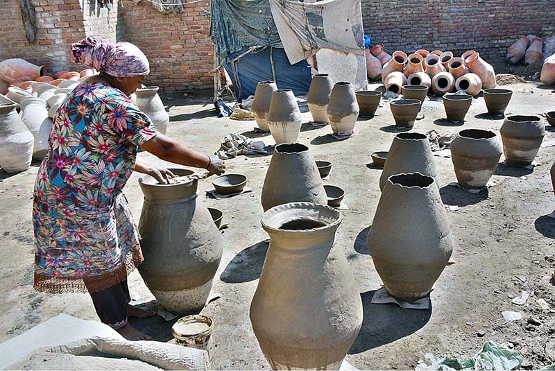 A craftswoman preparing clay-made pots in connection with World Women’s Day at Kumhar Para