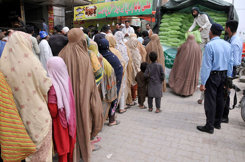 A large number of women in a queue to collect government free flour in connection with Ramzan ul Mubarak at Khana pull in the Federal Capital