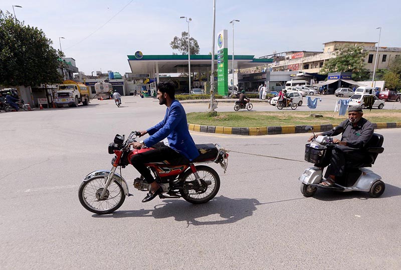 A motercyclist tochain and pulling special person scooty near khada market