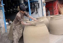 An artisan busy in preparing traditional oven “Tandoor” at his workplace in the Provincial Capital