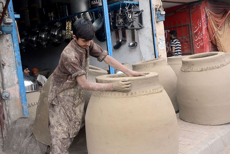 An artisan busy in preparing traditional oven “Tandoor” at his workplace in the Provincial Capital
