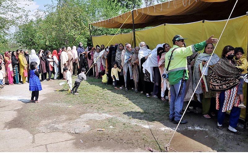 : March 20 - A large number of people standing in queue to get free flour bags under “Ramadan Package” at G-7 in Federal Capital. APP/SAK/MAF/TZD