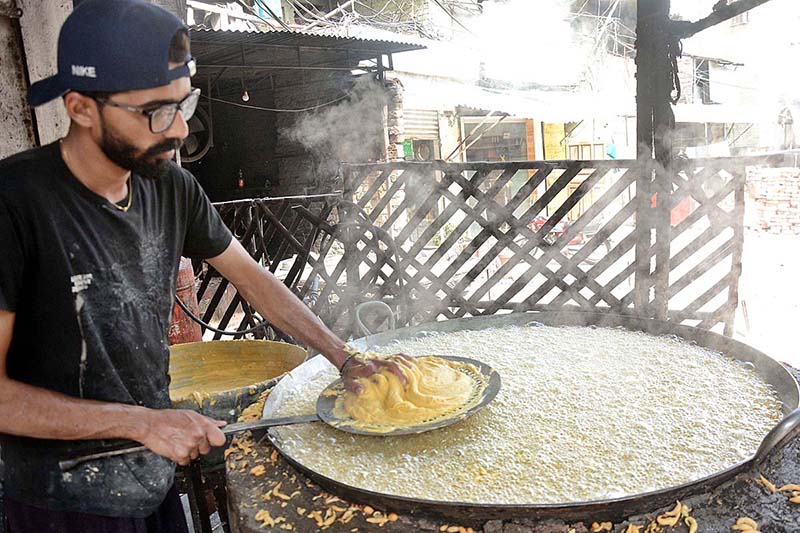 A worker busy in making traditional food item (Pakoriyaa) mostly used in Dahi Bhalle during the Holy fasting month of Ramzan.