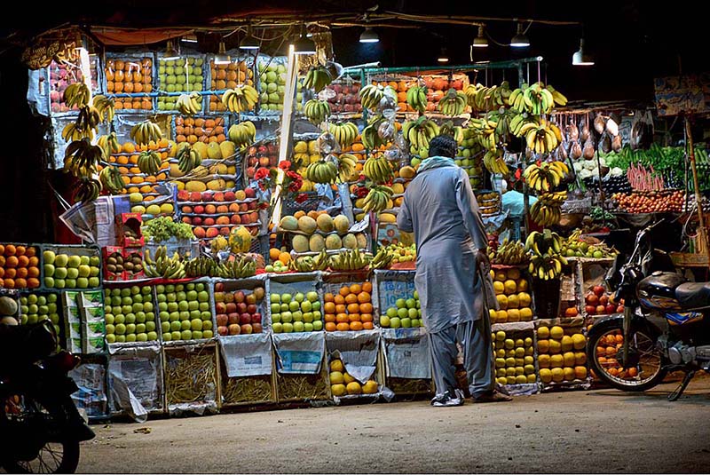 A vendor displaying the different seasonal fruits to attract the customers at his stall