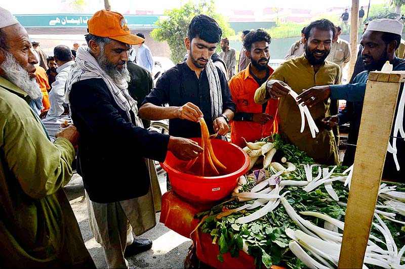 People purchasing radish from vendor at Khyber Road