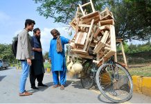 A street vender selling and displaying wooden stuff to the customers