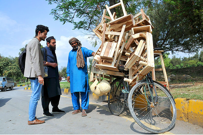 A street vender selling and displaying wooden stuff to the customers