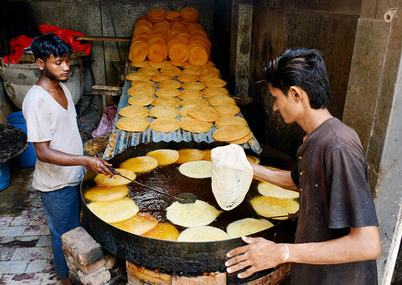 Workers busy in preparing vermicelli (Pheoni) during Holy fasting month of Ramazan at his workplace