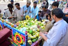 People busy in purchasing fresh fruit melons from vendors during a Holy month of Ramazan