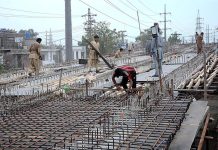 Laborers busy in construction work of road during development work in Provincial Capital.