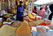 Women purchasing spices for upcoming Holy Month Ramadan at Margalla Ramzan Bazar.
