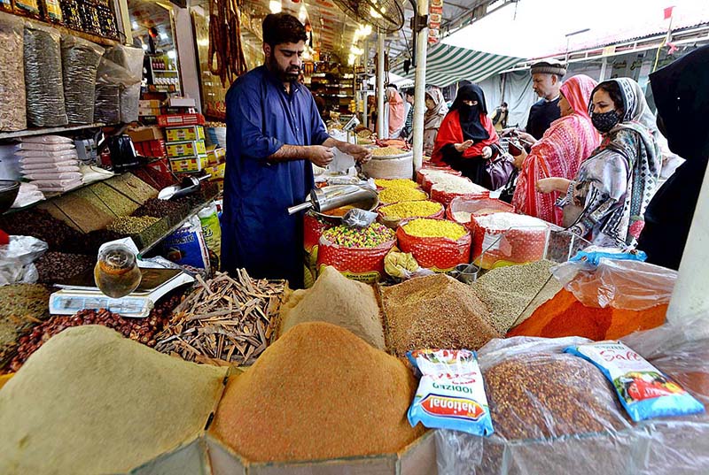 Women purchasing spices for upcoming Holy Month Ramadan at Margalla Ramzan Bazar.
