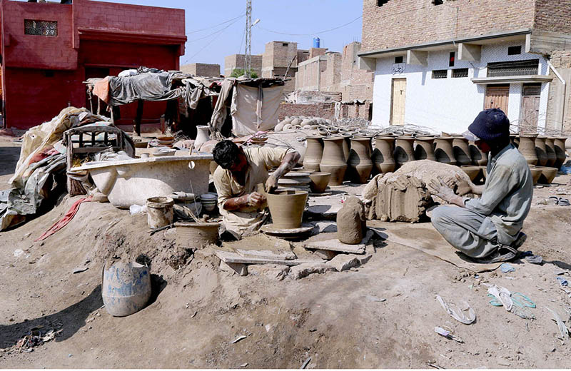 Craftsmen busy in preparing clay made items at their workplace at Kumarpara