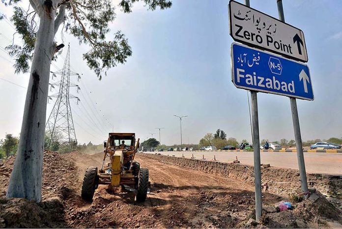 Heavy machinery being used for extension work of Murree Road during development work in Federal Capital