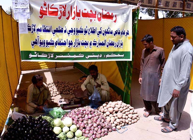 People busy in purchasing fresh vegetables from vendors at Ramzan bachat Bazar during holy month of Ramzan near Railway Station