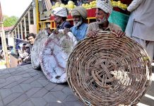 Labourers waiting for customers at sasta bazar during holy fasting month of Ramazan in the Federal Capital