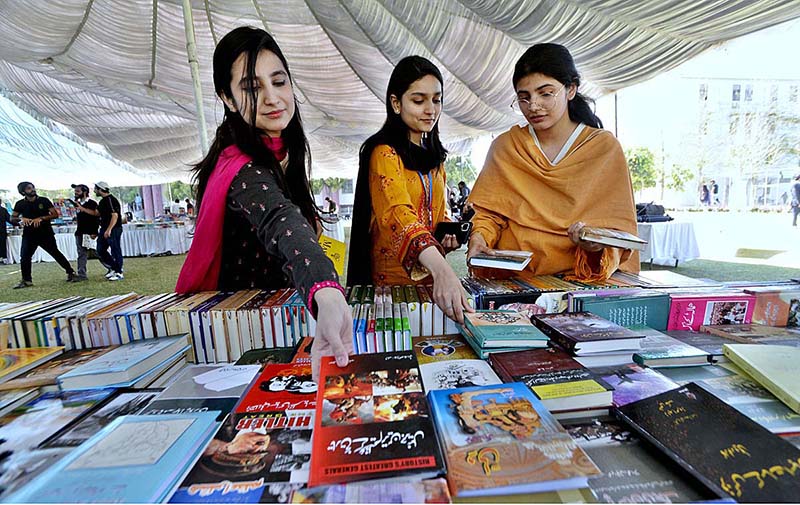 Students are taking keen interest in books at a stall during the 3 days “Book Fair” at NUML