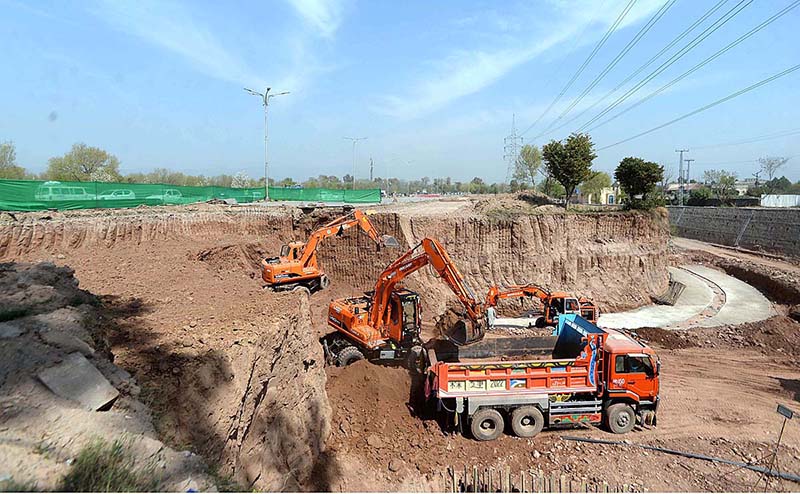 Heavy machinery being used for extension work of Murree Road during development work in Federal Capital