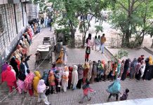 A large number of women in a queue to collect government free flour in connection with Ramzan ul Mubarak at Sitara Market in the Federal Capital