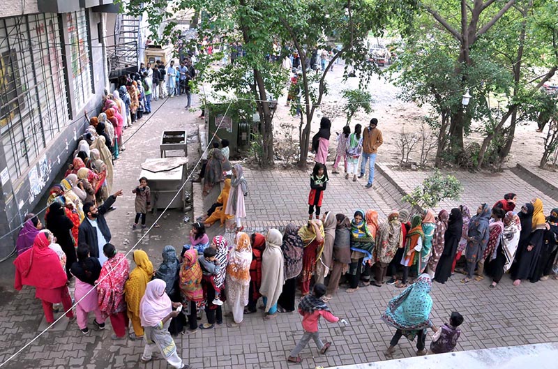 A large number of women in a queue to collect government free flour in connection with Ramzan ul Mubarak at Sitara Market in the Federal Capital