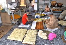 Workers busy preparing traditional items ‘samosa’ on the first day of Holy Fasting Month of Ramzan at Tower Market